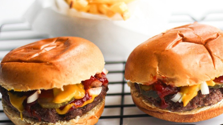 hamburgers with mustard and pickles