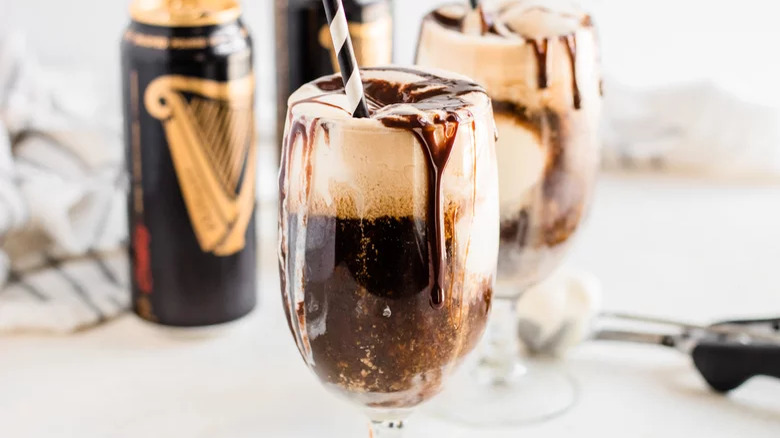 two guinness floats with straws