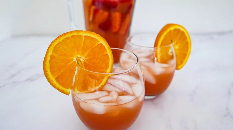 Two cocktails with orange wheels