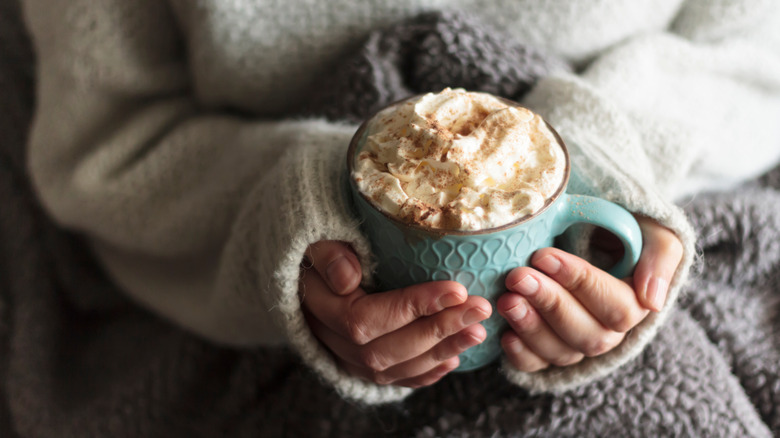 cozy hands holding hot chocolate