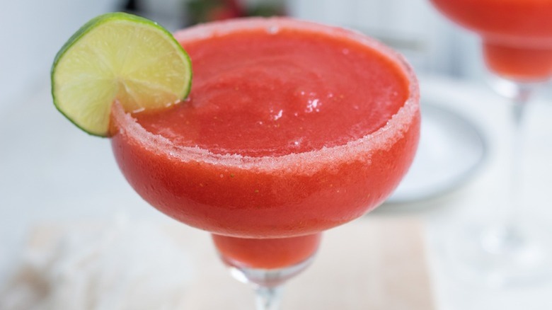 strawberry margarita with lime garnish