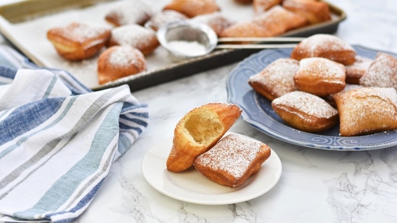 beignets on plates and a tray