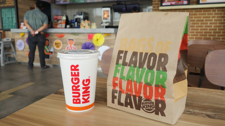 Burger King takeout bag and cup on table