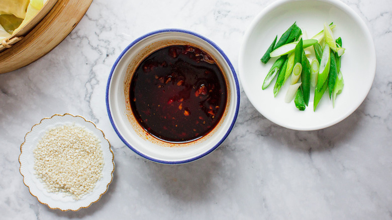 dumpling sauce with sesame seeds and scallions