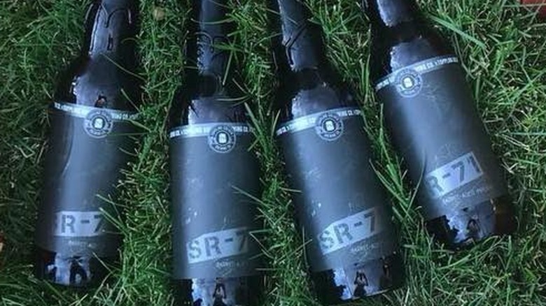 SR-71 beer bottles in grass