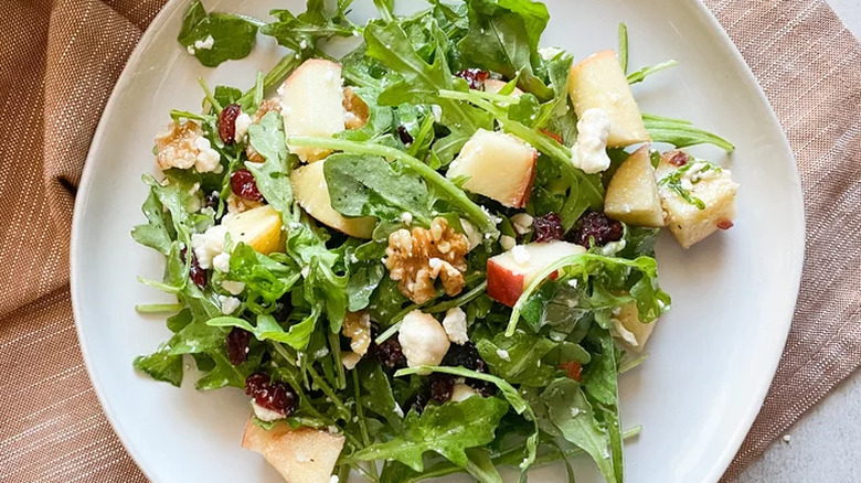 Green salad with diced apple and walnuts.