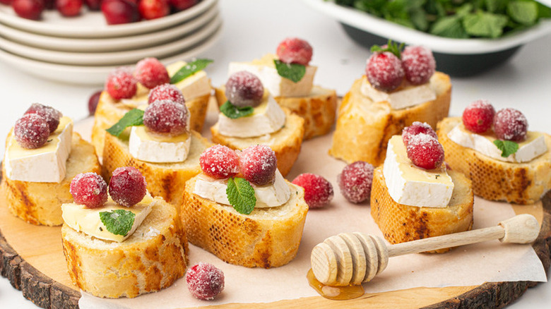 Baguette slices with brie and sugared cranberries.