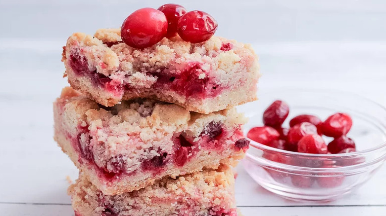 Cookie bars with cranberry layer and whole cranberries.