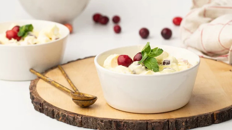 Bowls of creamy cranberry dessert with mint leaves.