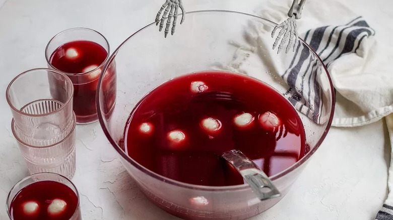 Bowl of red punch with floating, white lychee.