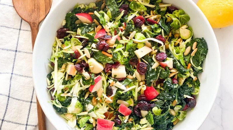 Bowl of kale, apple, and dried cranberry salad.