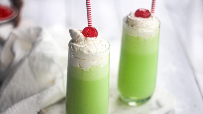 green-colored milkshakes with straws