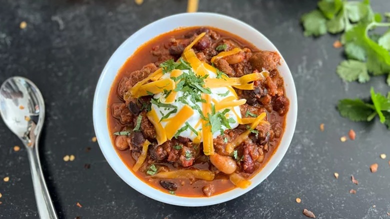 beer chili with sour cream, cheese, and cilantro