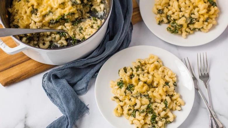 pots and plates of macaroni and cheese