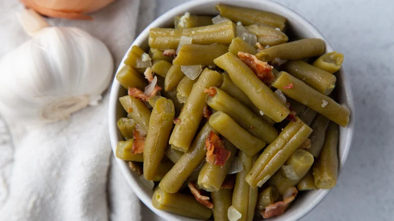 Green beans with onions and bacon, and garlic bulb