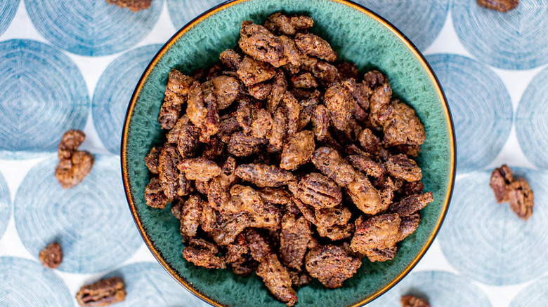 blue bowl of candied pecans