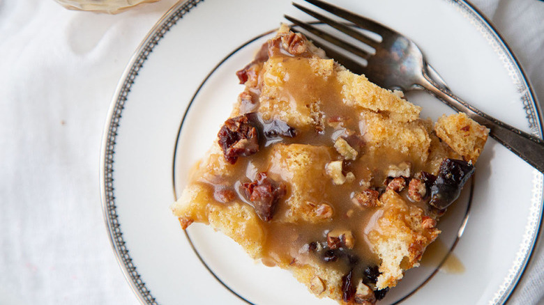 plate with cherry pecan bread pudding and fork