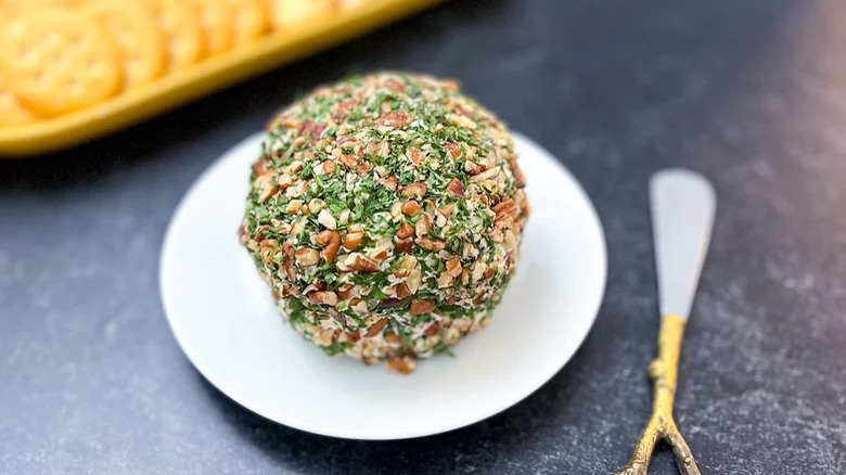 cheese ball on plate with knife