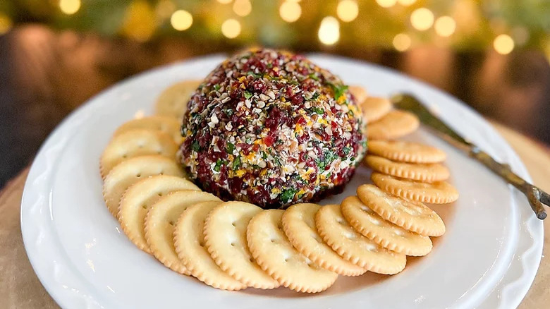 plate with cranberry orange cheese ball and crackers