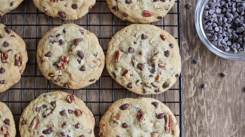 wire rack with toll house chocolate chip cookies and chocolate chips