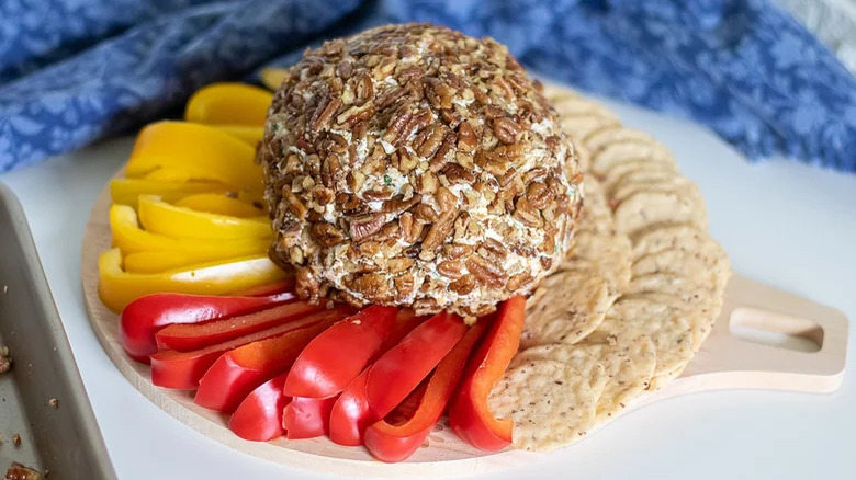 wooden board with easter cheese ball with crudite and crackers