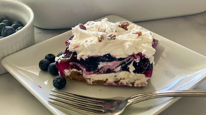 plate with layered blueberry delight and fork