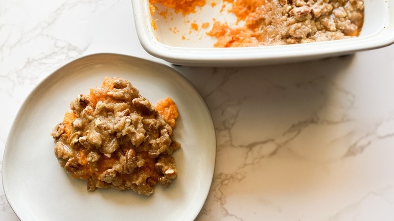 casserole dish and plate with sweet potato casserole