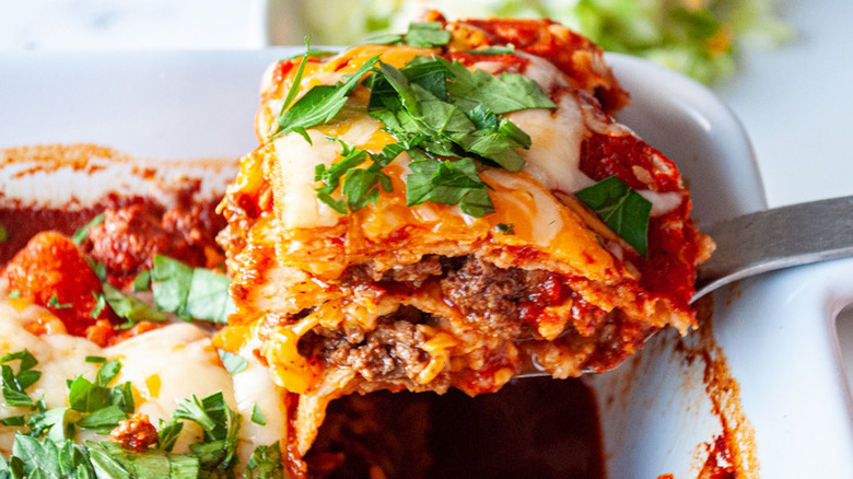 Baked casserole with beef, tortillas, cheese, and herbs.