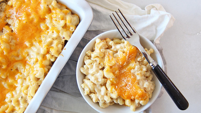 Baking dish and small plate with mac and cheese.