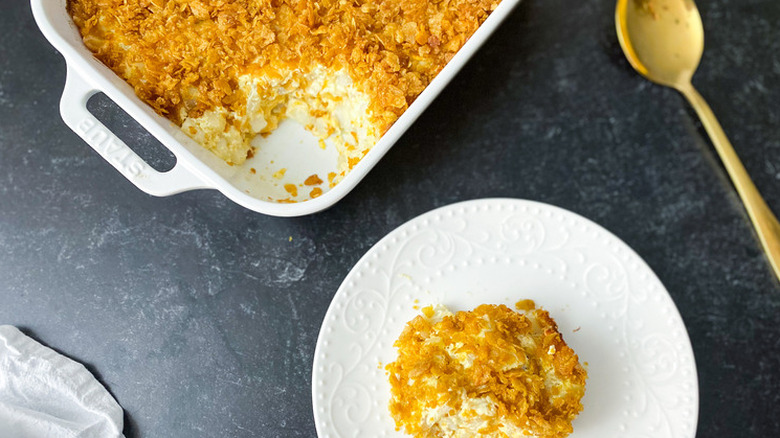 Dish of baked potato casserole topped with corn flakes.