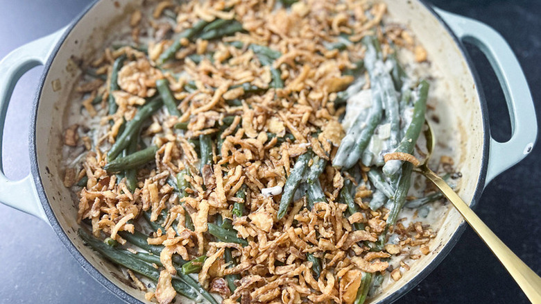 Dutch oven with green beans, fried onions, and cream sauce.