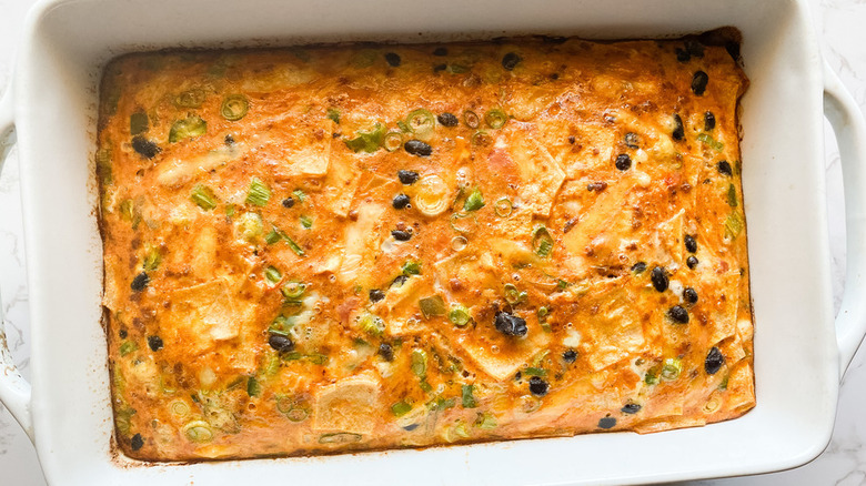 Egg bake with black beans, scallions, and tortilla pieces.