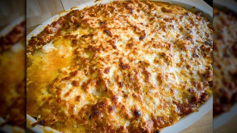 Oval dish with cheese-topped baked lasagna.