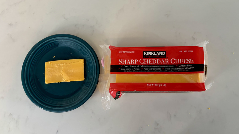 Block of orange cheddar cheese