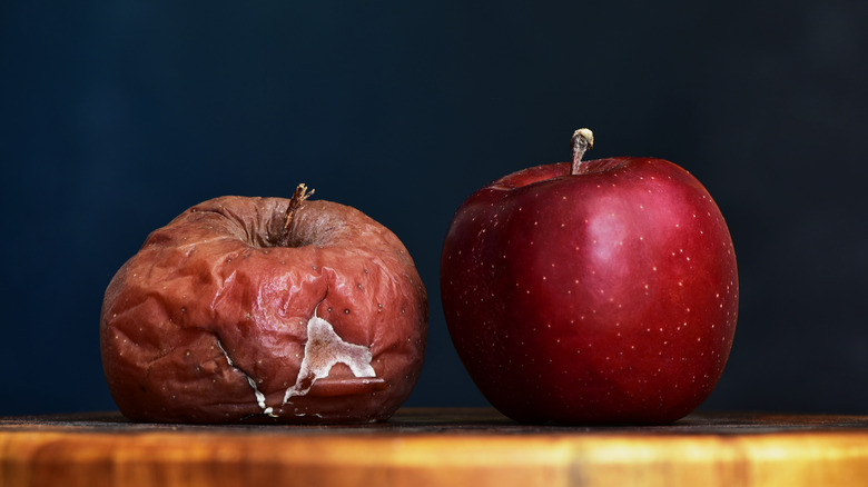 Rotten apple and fresh apple