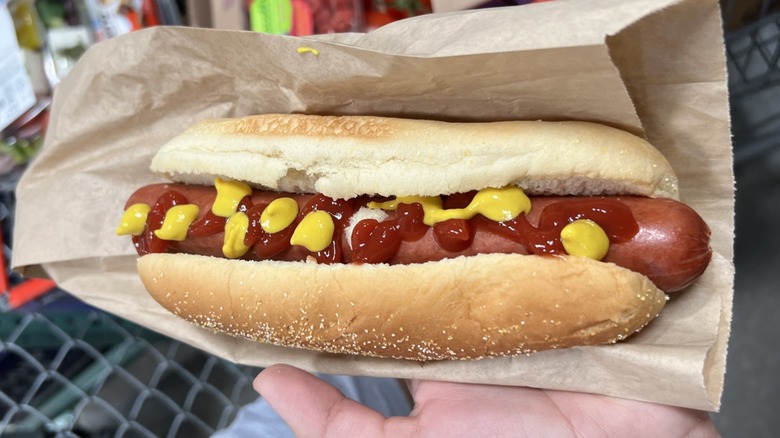 hand holding Costco hot dog