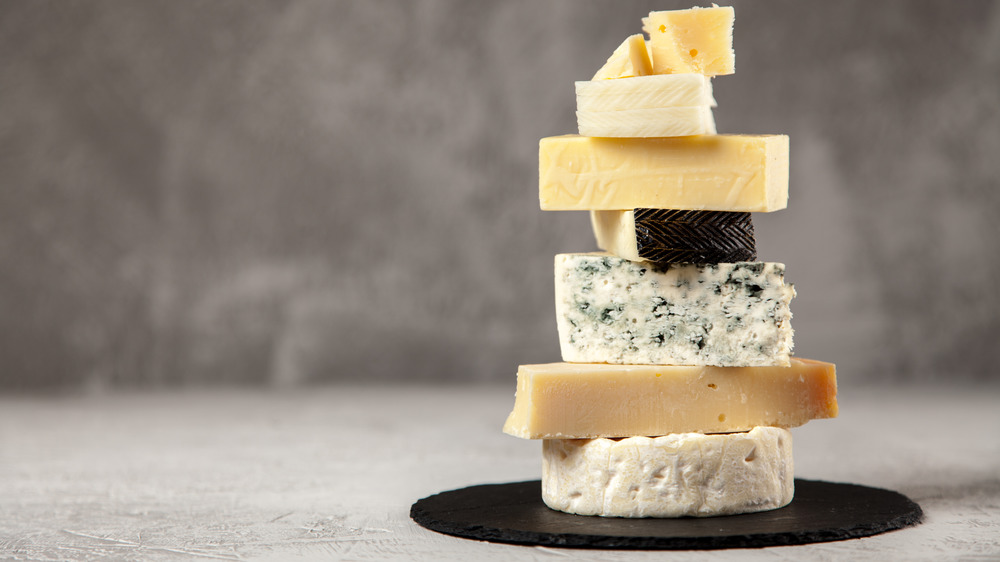 stack of hard and blue cheeses