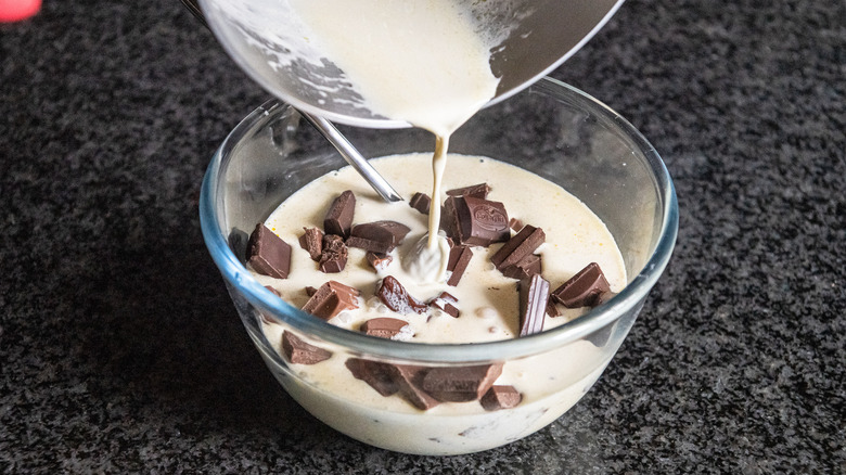 pouring hot cream over chocolate