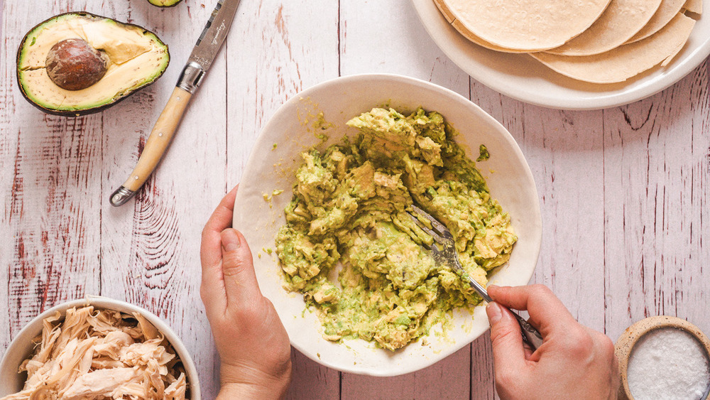 mashing avocado