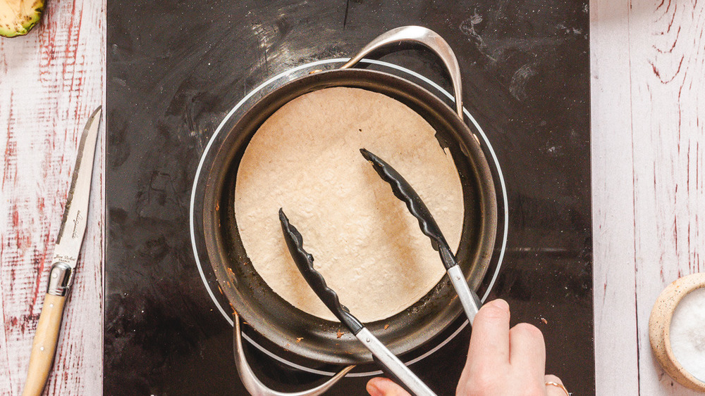 toasting tortillas on pan