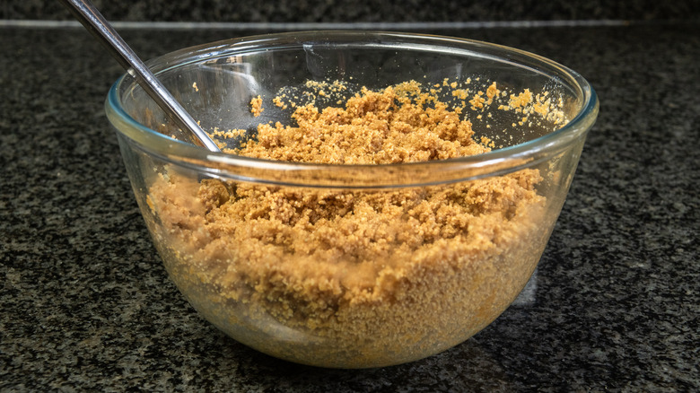 Cookie crumbs and butter in bowl 