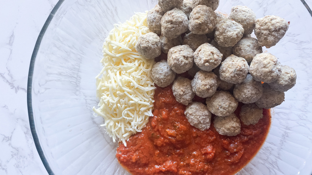 mixing ingredients for 5-ingredient meatball pasta bake