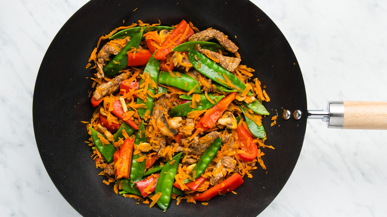 veggies and pork in wok 