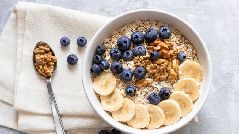 a bowl of oatmeal with fruit and nuts