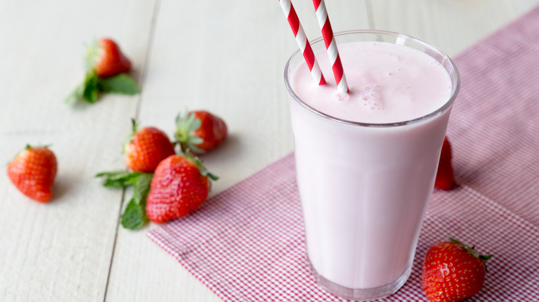 glass of strawberry milk with strawberries