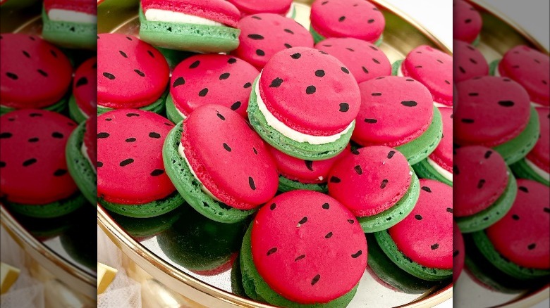 watermelon colored macarons on plate