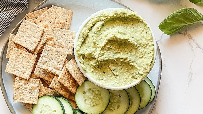 green hummus with crackers