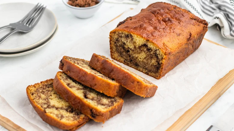 loaf of cinnamon bread with slices and forks