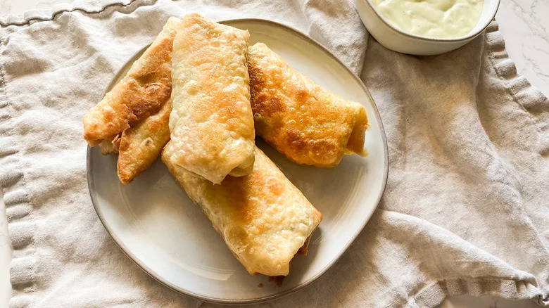 plate of southwest egg rolls with ranch dipping sauce