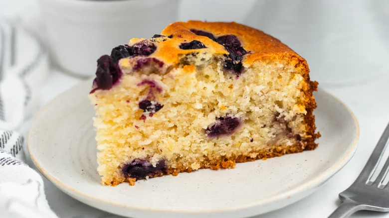 slice of lemony blueberry cake on plate with fork
